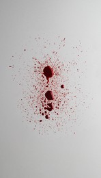 Photo of Stain and splashesblood on light grey background, top view