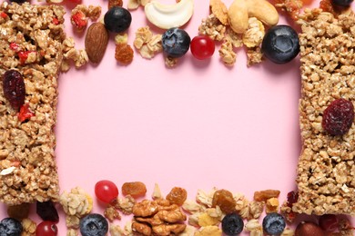 Frame made of tasty granola bars and ingredients on pink background, top view. Space for text