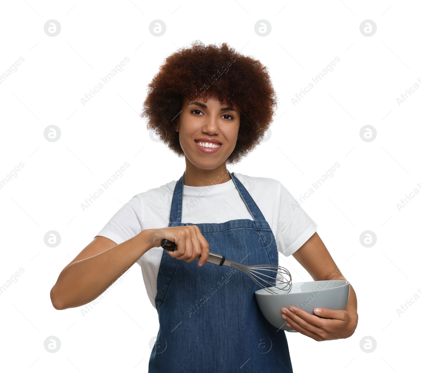 Photo of Happy young woman in apron holding bowl and whisk on white background