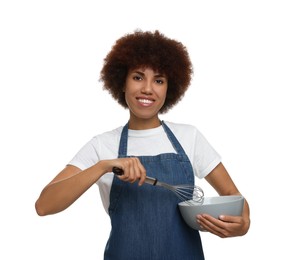 Happy young woman in apron holding bowl and whisk on white background