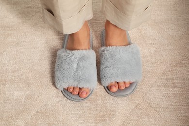 Woman wearing soft slippers at home, closeup