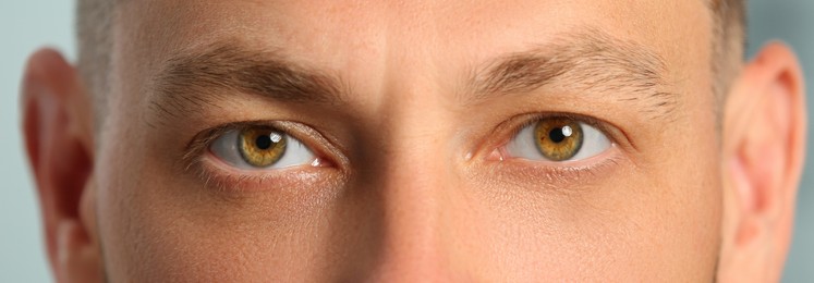 Closeup view of man with beautiful eyes. Banner design