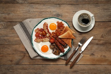 Traditional English breakfast served on wooden table, flat lay