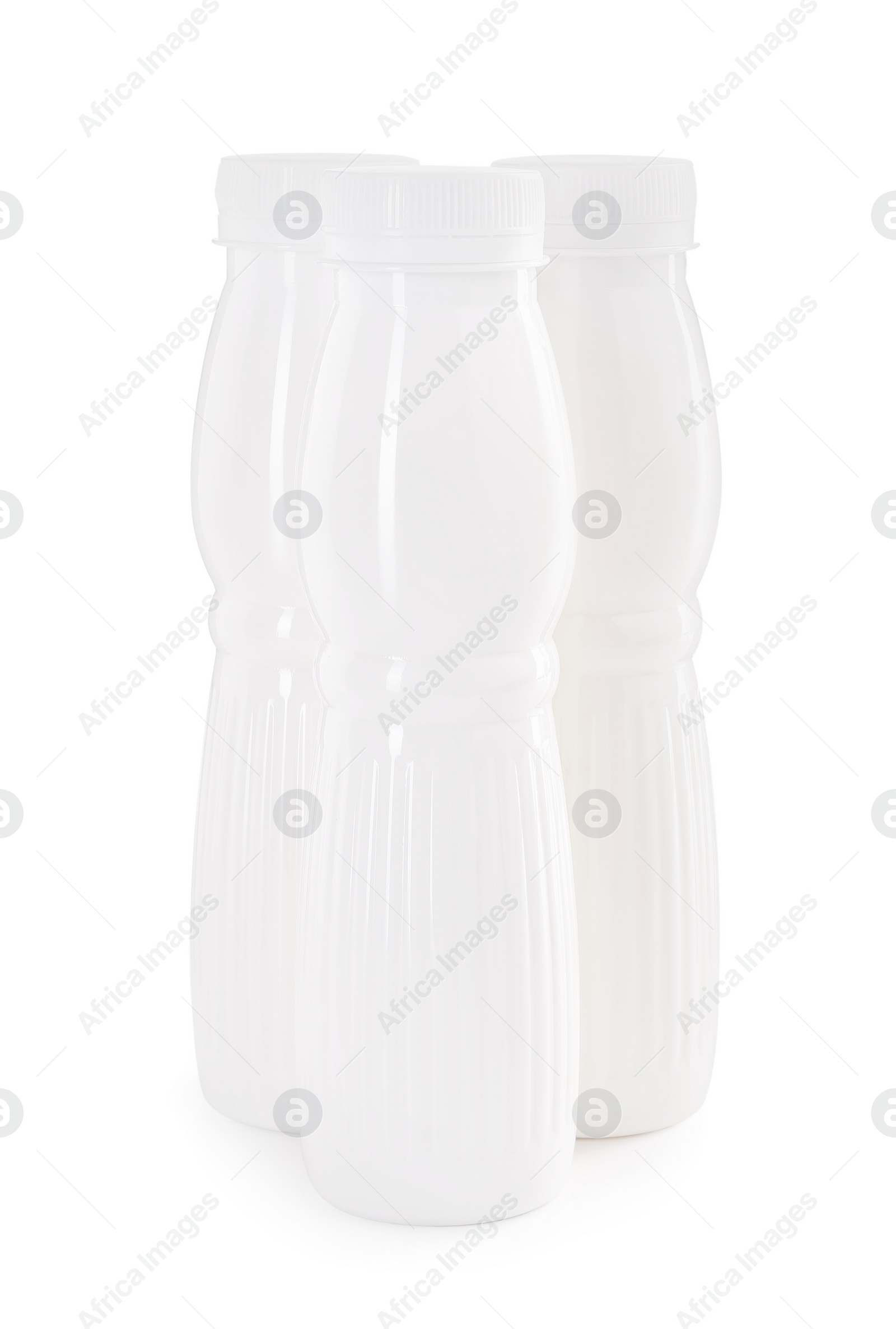 Photo of Tasty yogurt in bottles isolated on white