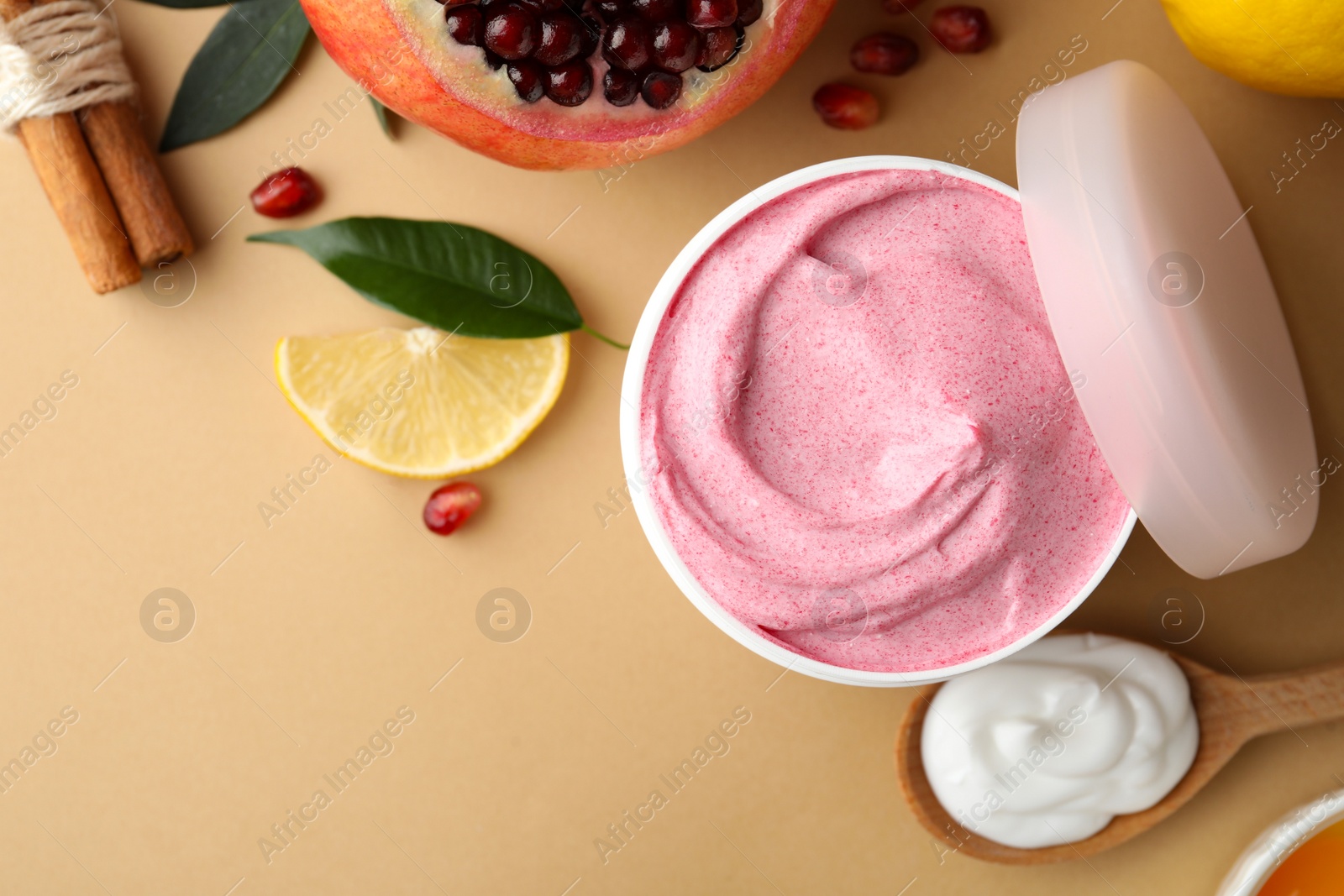 Photo of Flat lay composition with natural homemade mask, pomegranate and ingredients on beige background