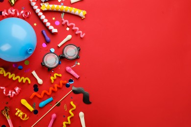 Photo of Flat lay composition with carnival items on red background. Space for text