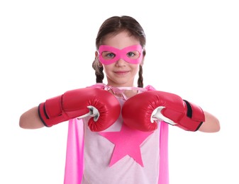 Photo of Cute little girl in superhero suit and boxing gloves on white background