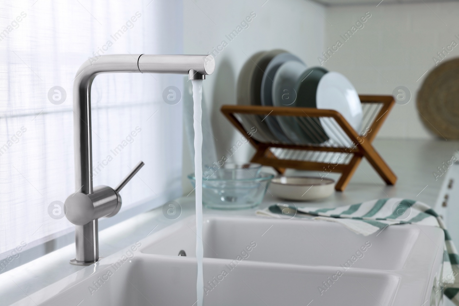 Photo of Stream of water flowing from tap in kitchen, space for text