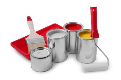 Photo of Cans of different paints, roller, brush and tray on white background