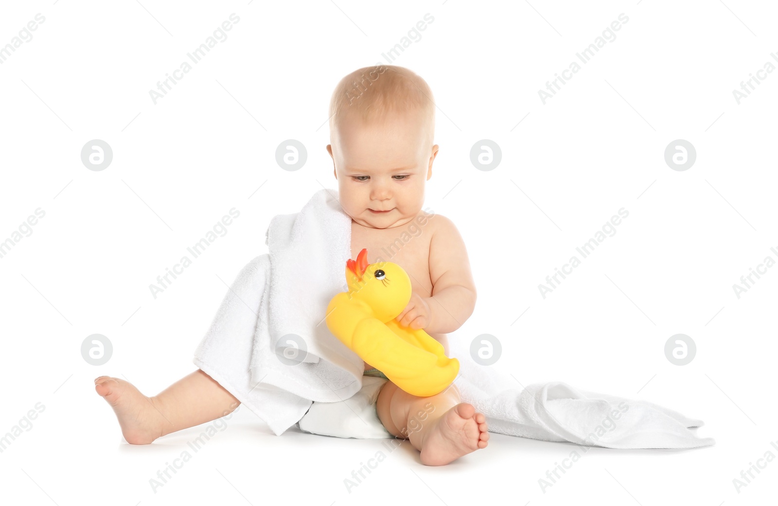 Photo of Cute little baby with soft towel and toy duck on white background