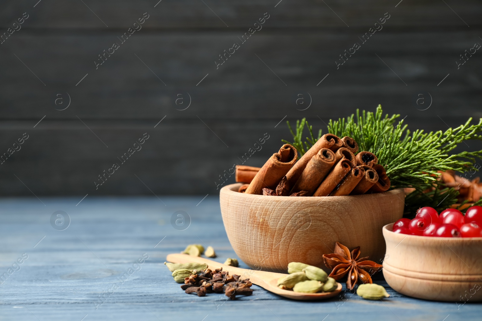 Photo of Composition with mulled wine ingredients on blue wooden table. Space for text