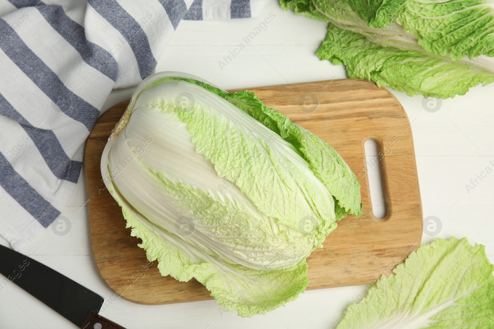 Photo of Fresh ripe Chinese cabbages on white wooden table, flat lay