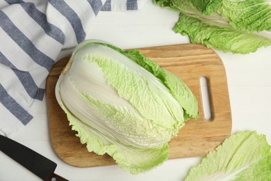 Fresh ripe Chinese cabbages on white wooden table, flat lay