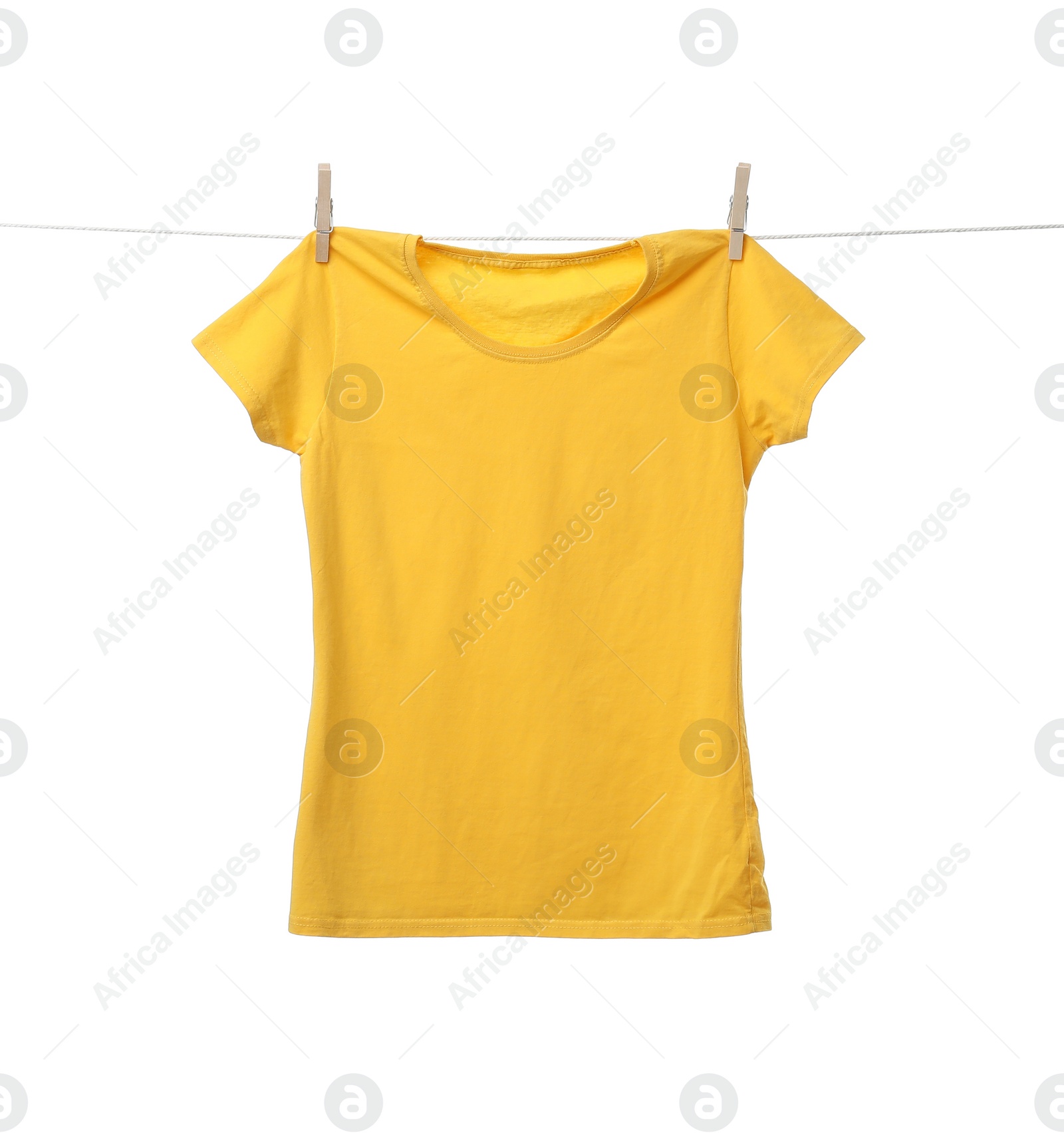 Photo of Yellow t-shirt drying on washing line against white background