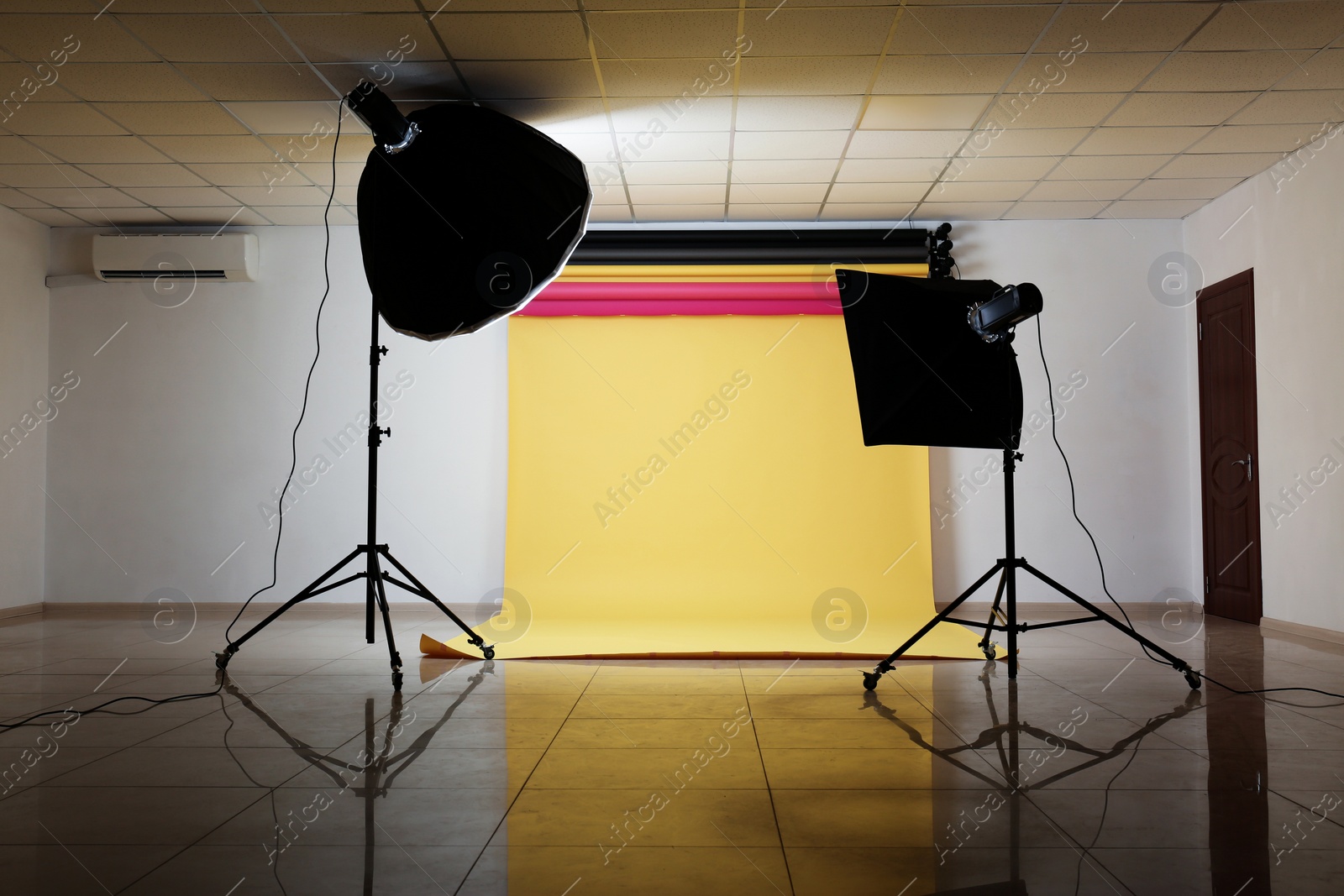 Photo of Interior of modern photo studio with professional lighting equipment