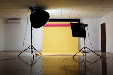 Interior of modern photo studio with professional lighting equipment