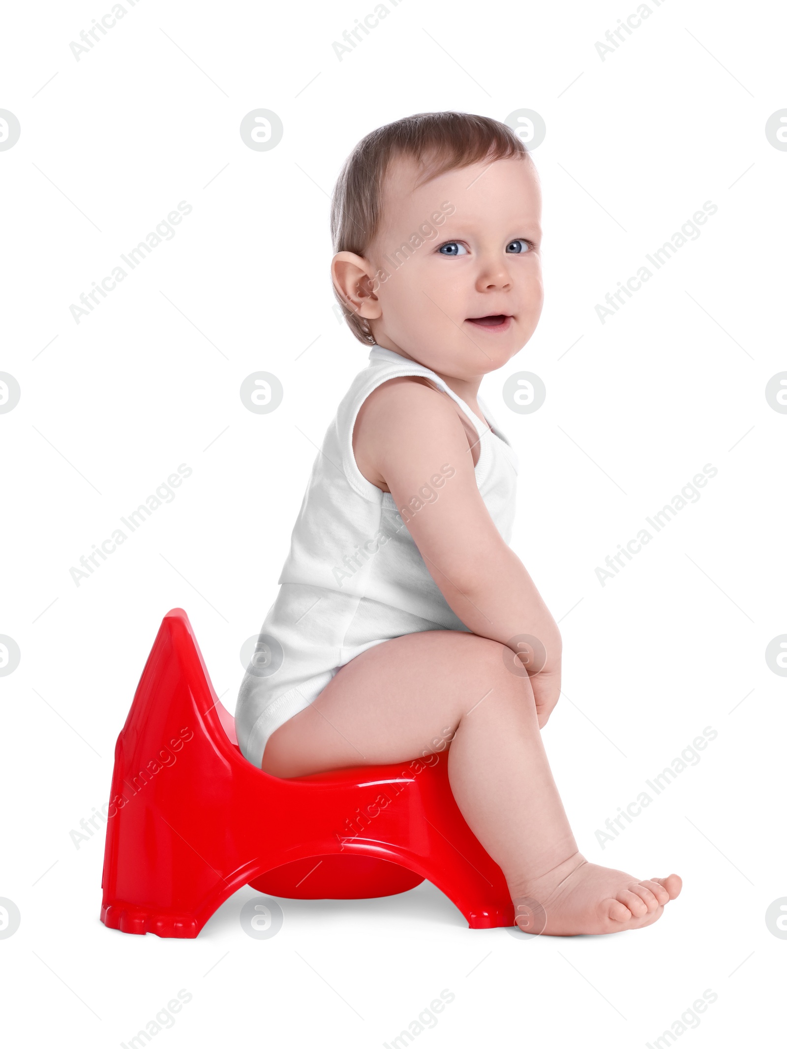 Photo of Little child sitting on baby potty against white background