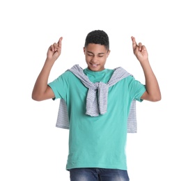 Photo of African-American teenage boy crossing his fingers on white background