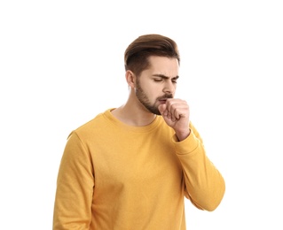 Photo of Handsome young man coughing against white background