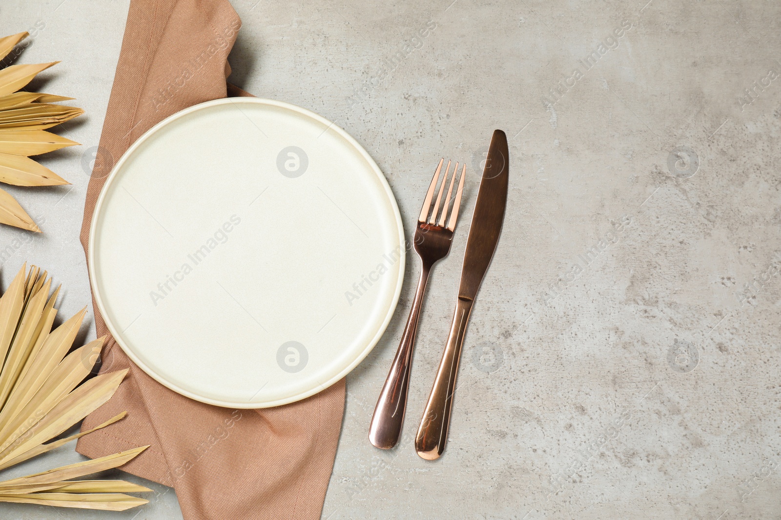 Photo of Setting with beautiful cutlery on textured table, top view. Space for text