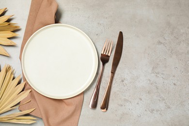 Photo of Setting with beautiful cutlery on textured table, top view. Space for text