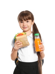 Schoolgirl with healthy food and backpack on white background