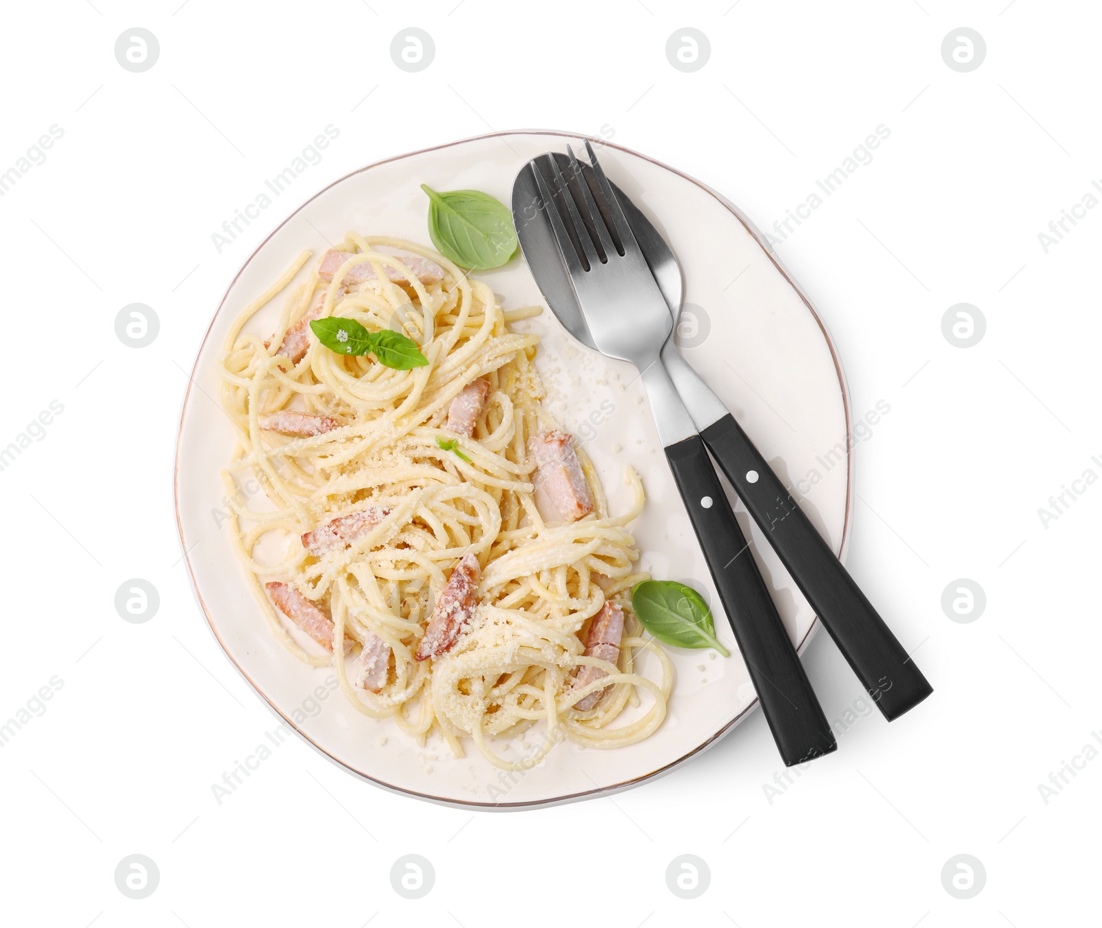 Photo of Plate of tasty pasta Carbonara with basil leaves isolated on white, top view