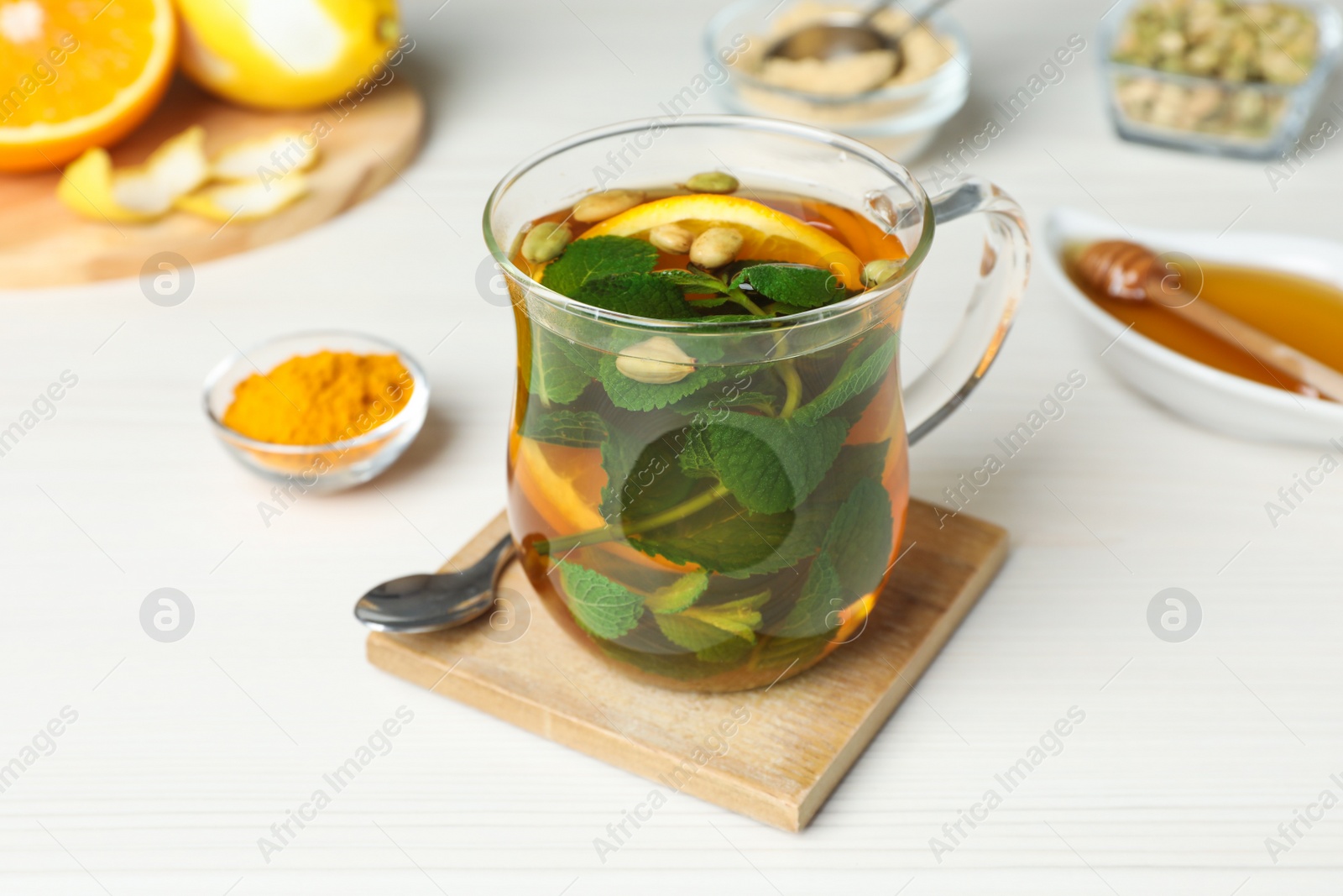 Photo of Immunity boosting drink on white wooden table