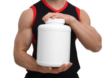 Young man with muscular body holding jar of protein powder on white background, closeup