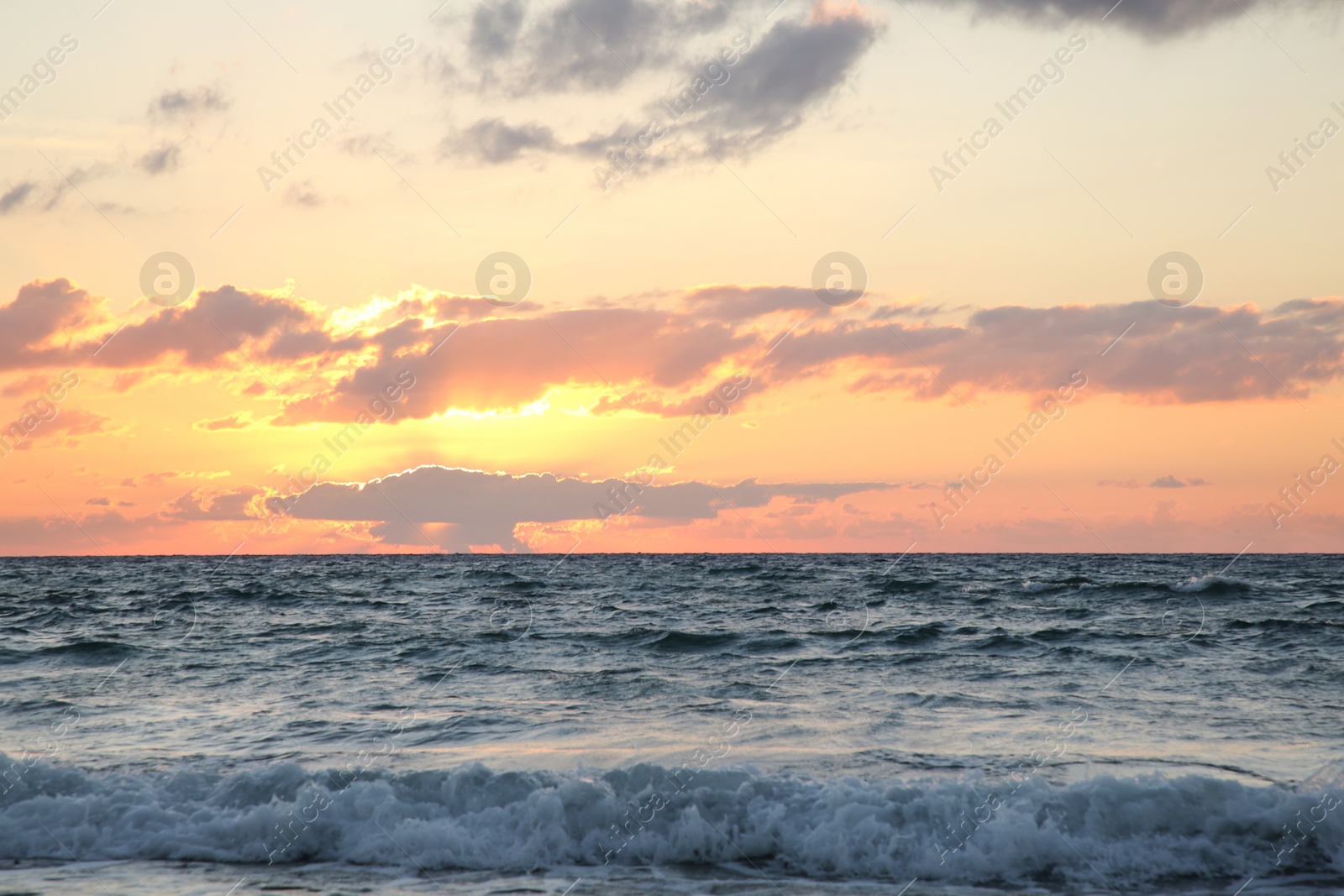 Photo of Picturesque view of sea under sky at beautiful sunset