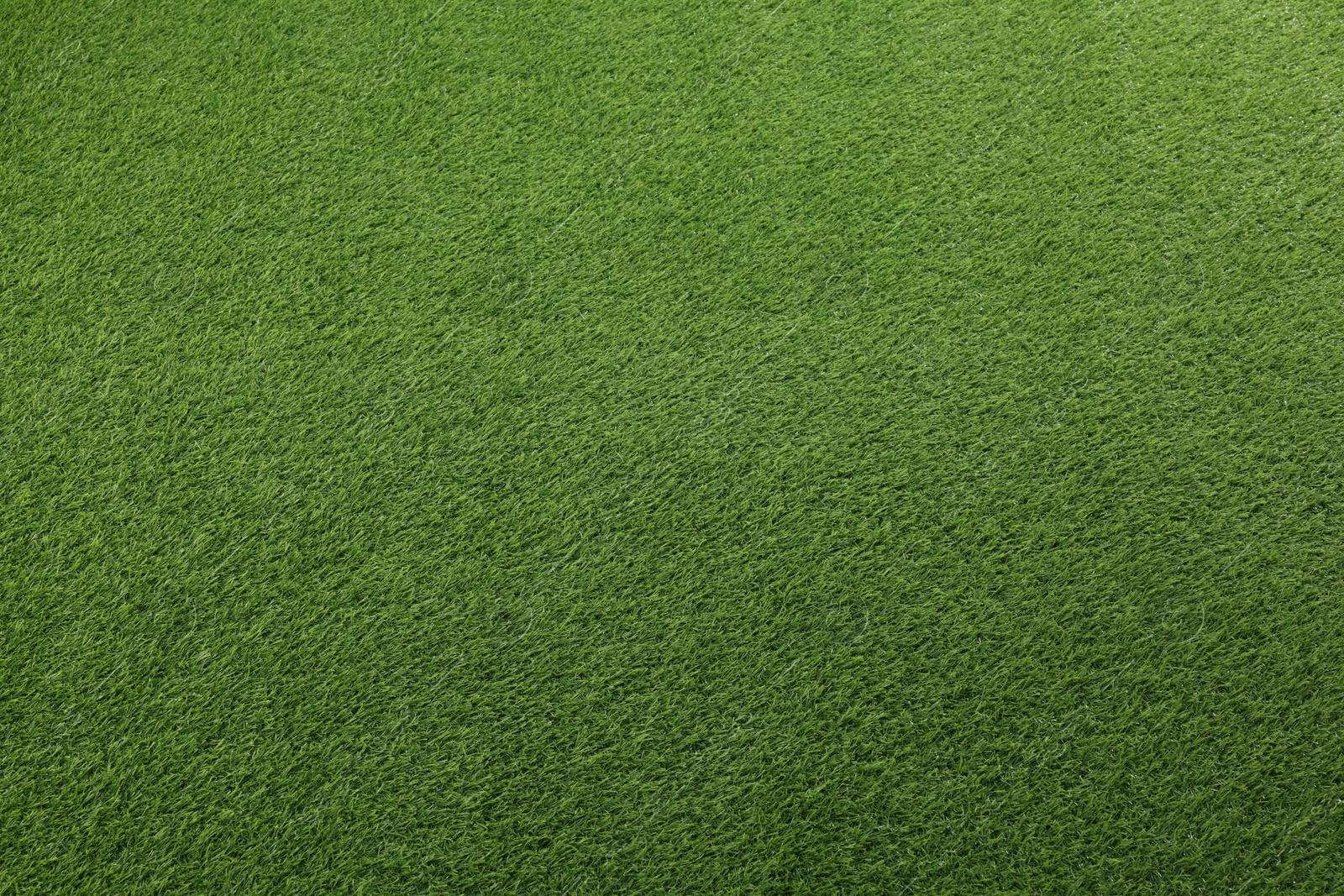 Photo of Green artificial grass as background, top view