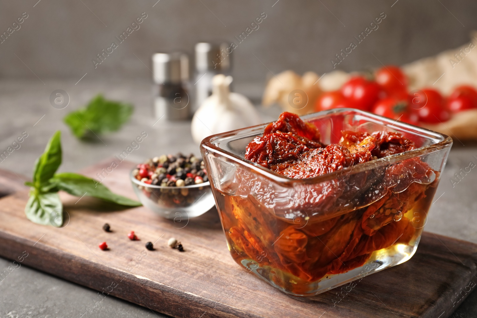 Photo of Dried tomatoes in glass bowl on table