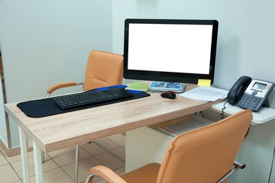Photo of Doctor's workplace with computer in modern clinic. Space for design
