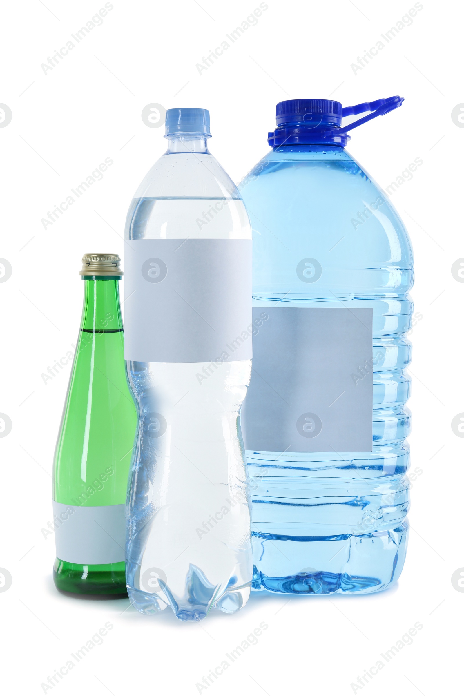 Photo of Different bottles of pure water with blank tags on white background