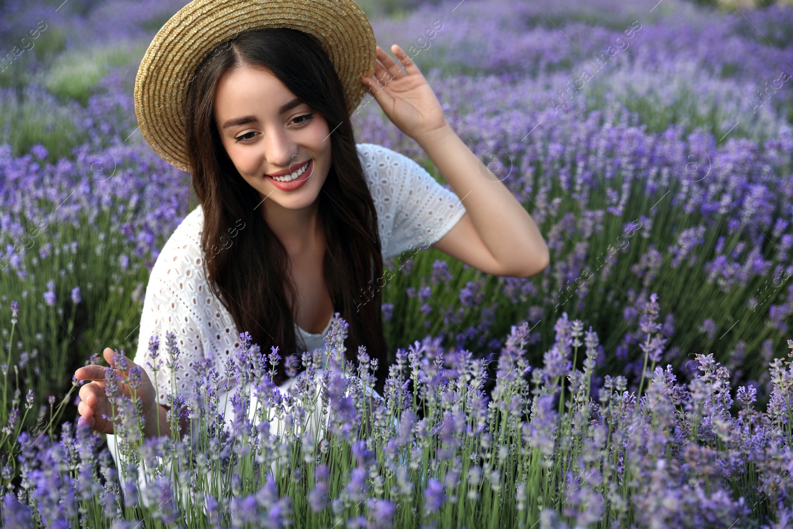 Photo of Young woman in lavender field on summer day