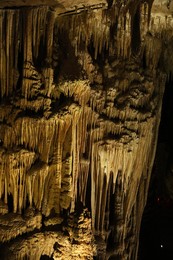 Photo of Picturesque view of many stalactite formations in cave