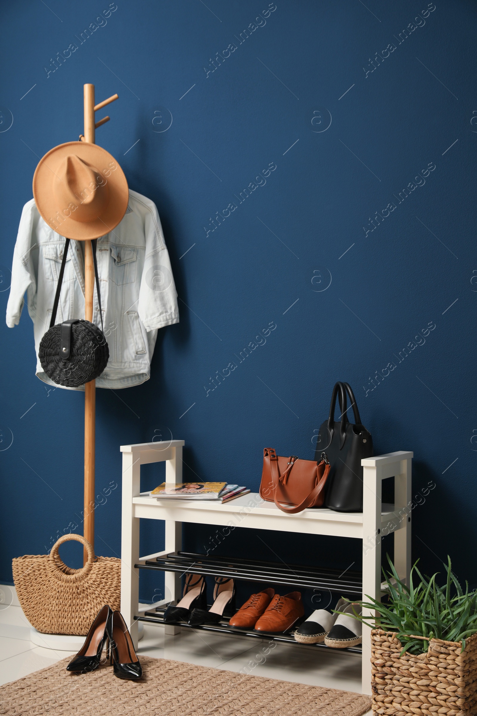 Photo of Hallway interior with stylish furniture, clothes and accessories