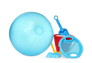 Inflatable light blue beach ball and child plastic toys on white background