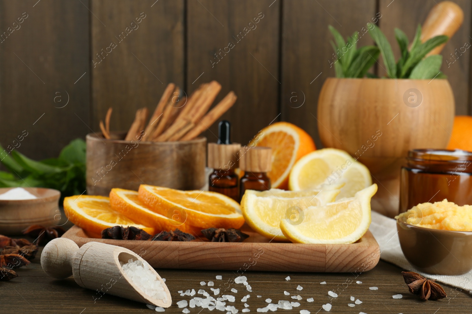 Photo of Homemade cosmetic products and fresh ingredients on wooden table