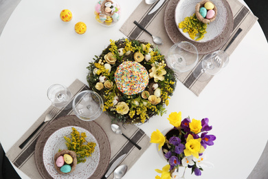Photo of Festive Easter table setting with beautiful floral decor and eggs, flat lay