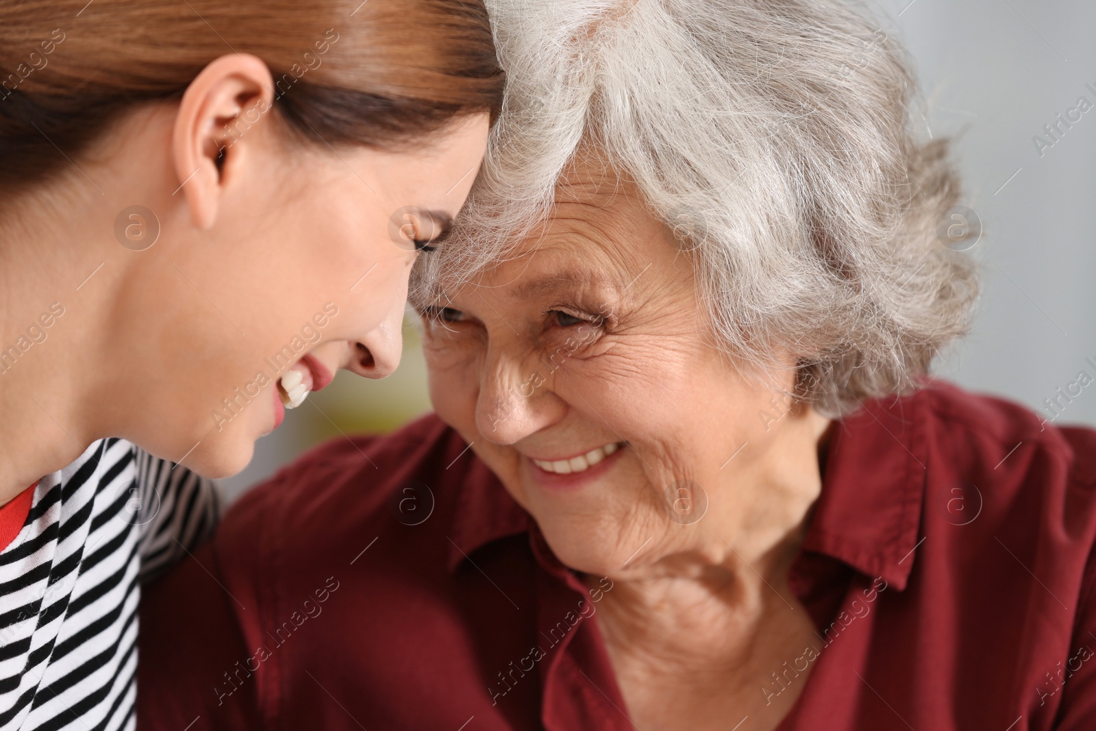 Photo of Elderly woman with female caregiver, closeup view