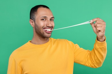 Photo of Happy man with bubble gum on green background