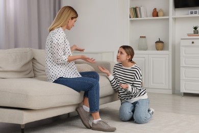 Photo of Mother and her teenage daughter having argument at home