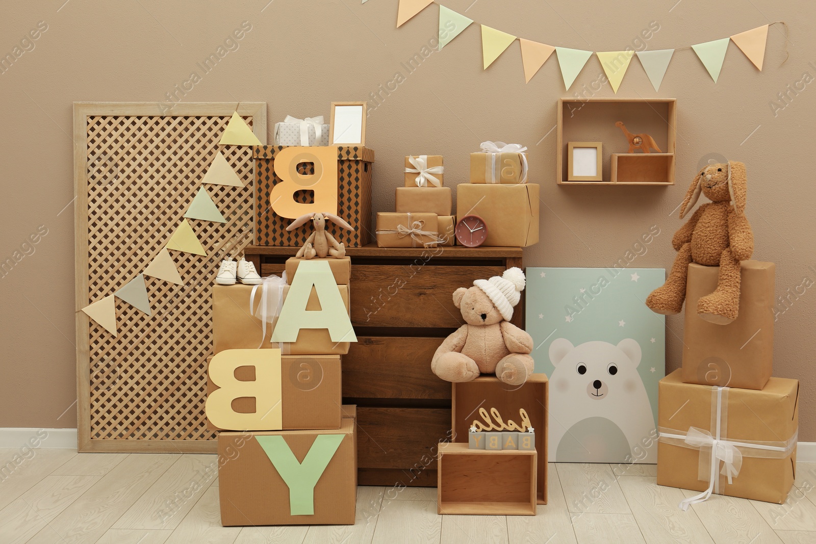 Photo of Gift boxes and toys in room decorated for baby shower party