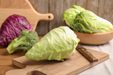 Photo of Different fresh cabbages on table. Healthy food