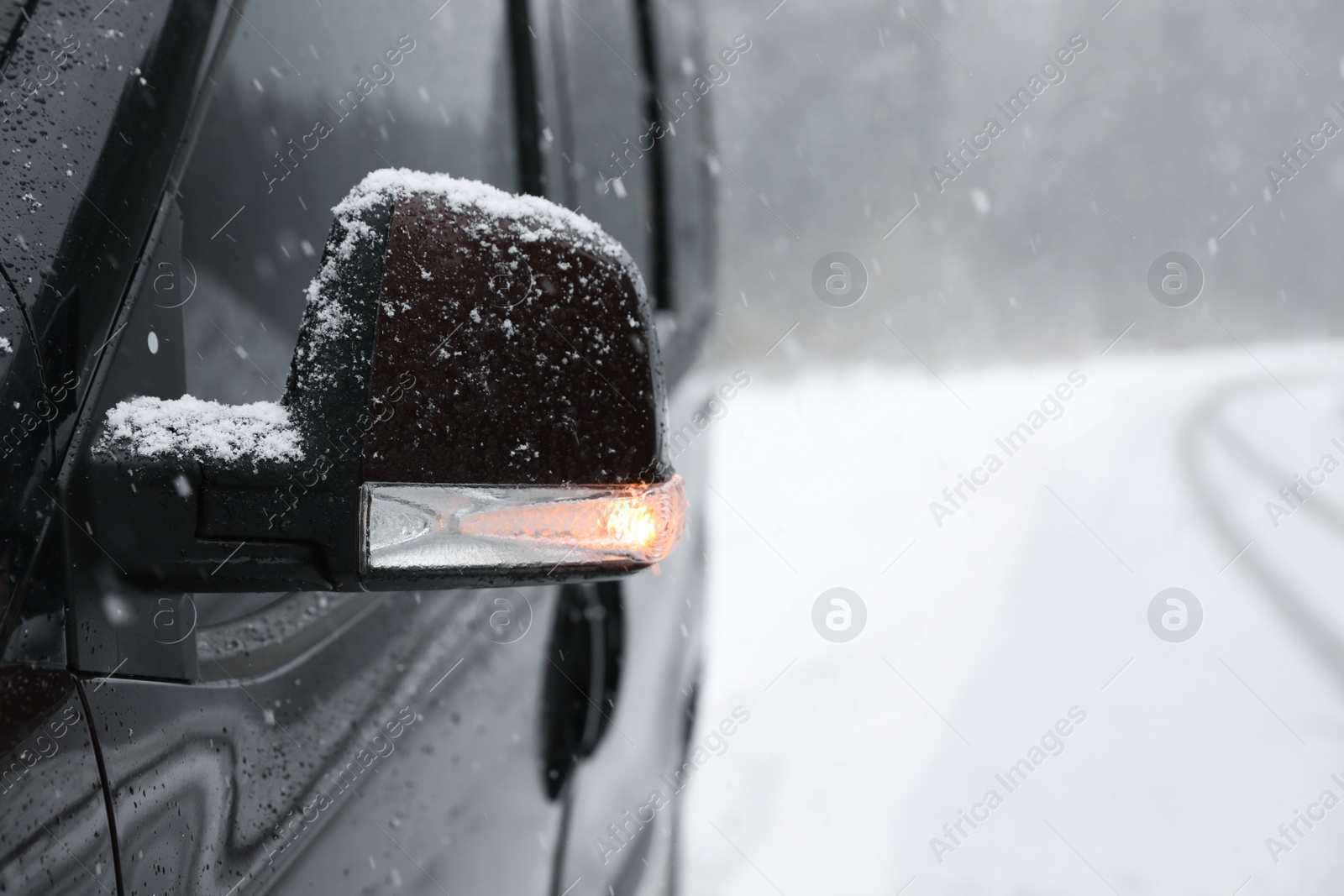 Photo of Car on snowy winter day, closeup view. Space for text