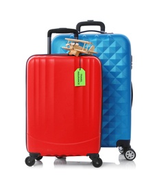 Red and blue suitcases with TRAVEL INSURANCE label on white background