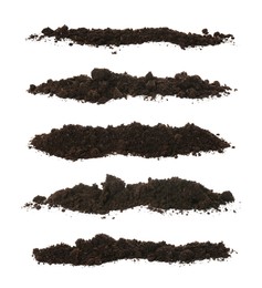 Set with piles of fertile soil on white background