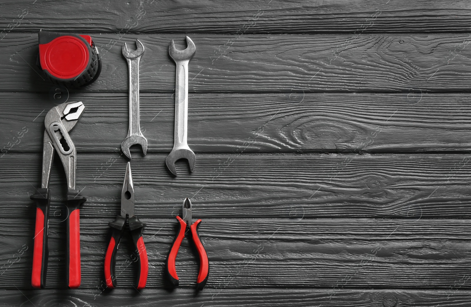 Photo of Flat lay composition with plumber's tools and space for text on wooden background