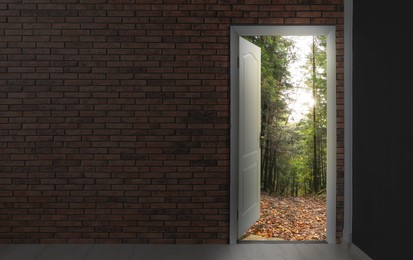 Open door in brick wall inviting to visit autumn forest